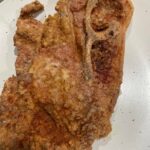 Crispy batter fried pork steak fresh from skillet