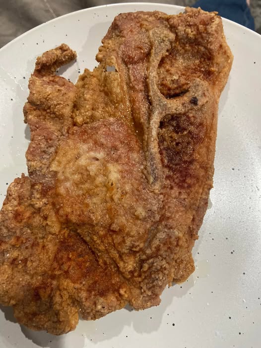 Crispy batter fried pork steak fresh from skillet