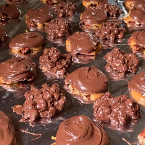Freshly made homemade turtle candies with creamy chocolate and chewy caramel.