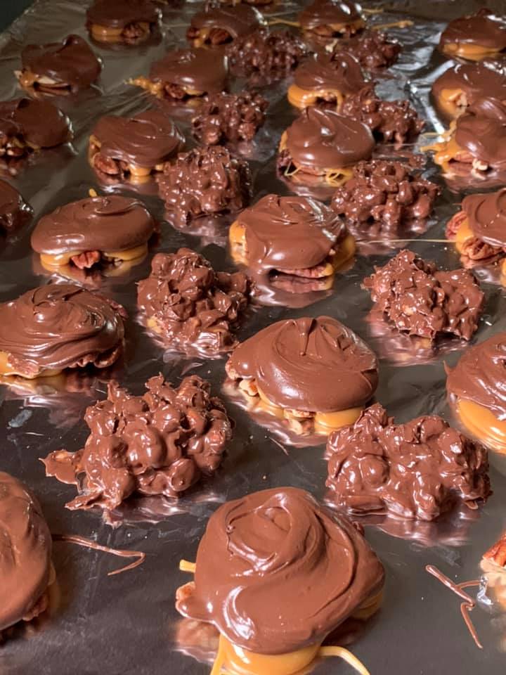 Freshly made homemade turtle candies with creamy chocolate and chewy caramel.