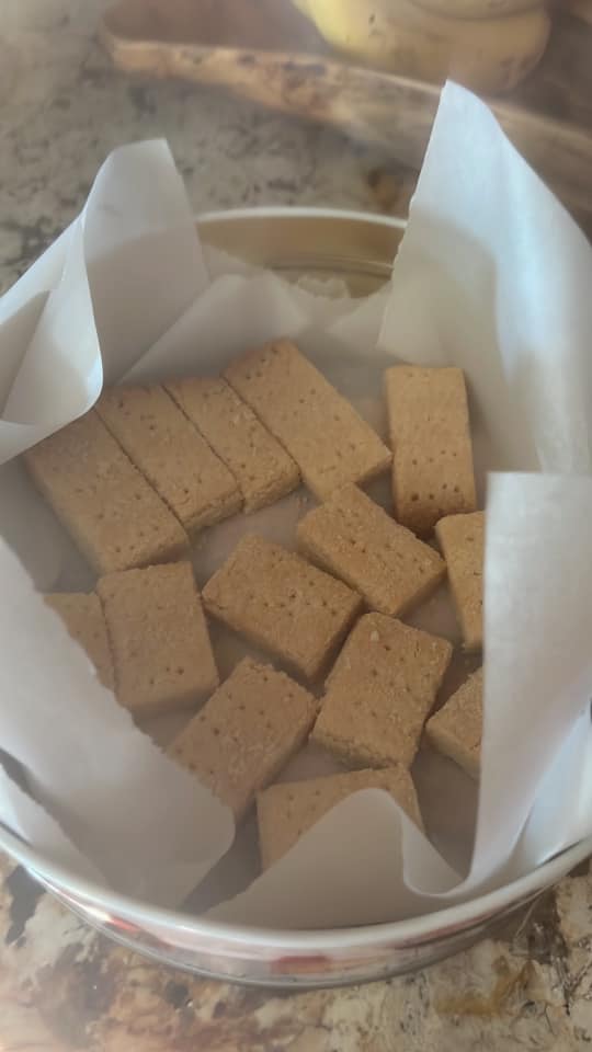 Homemade Scottish shortbread cookies, neatly stacked in a tin, ready for gifting or snacking