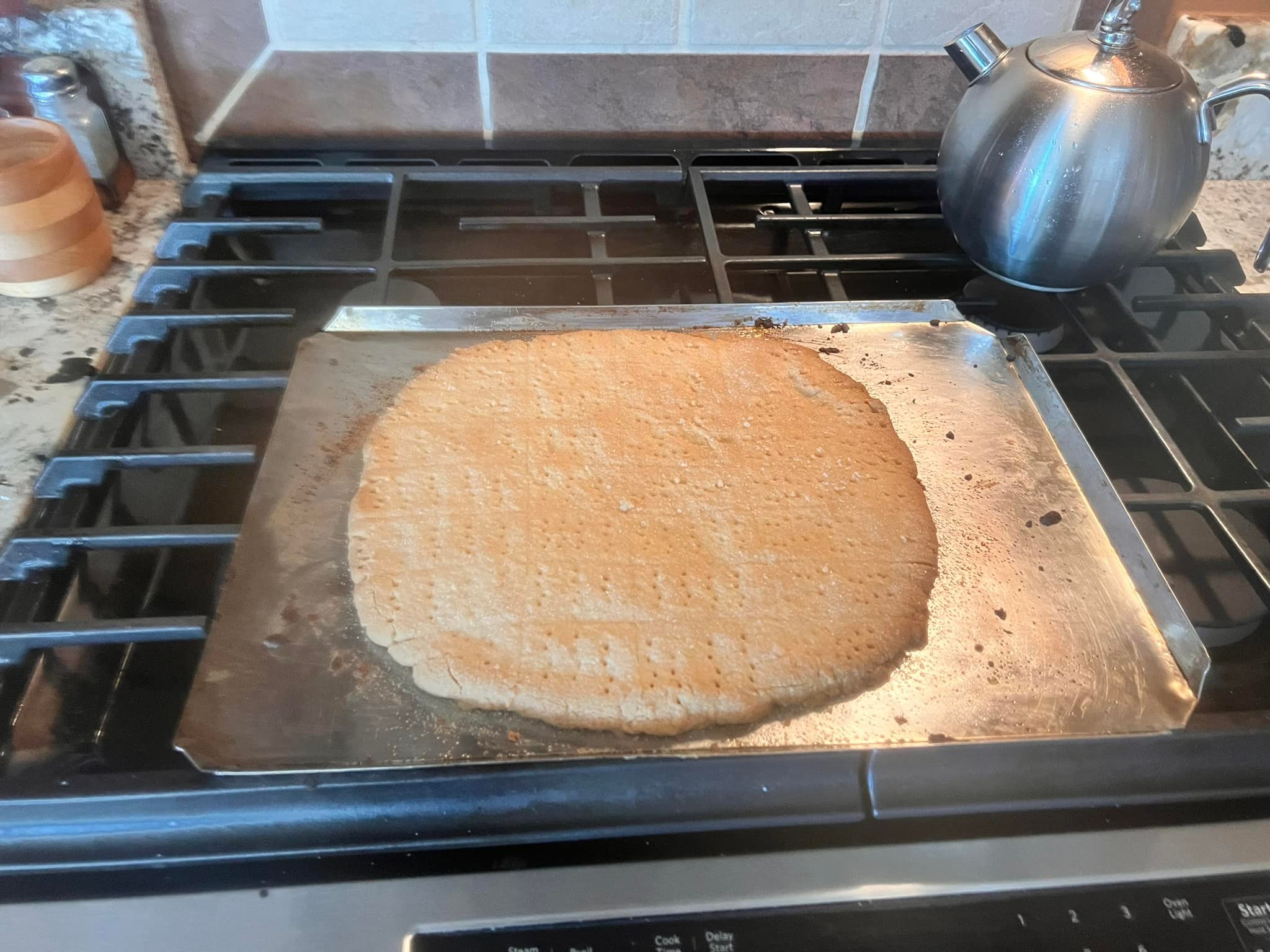 Scottish shortbread dough pressed and shaped on baking tray before baking