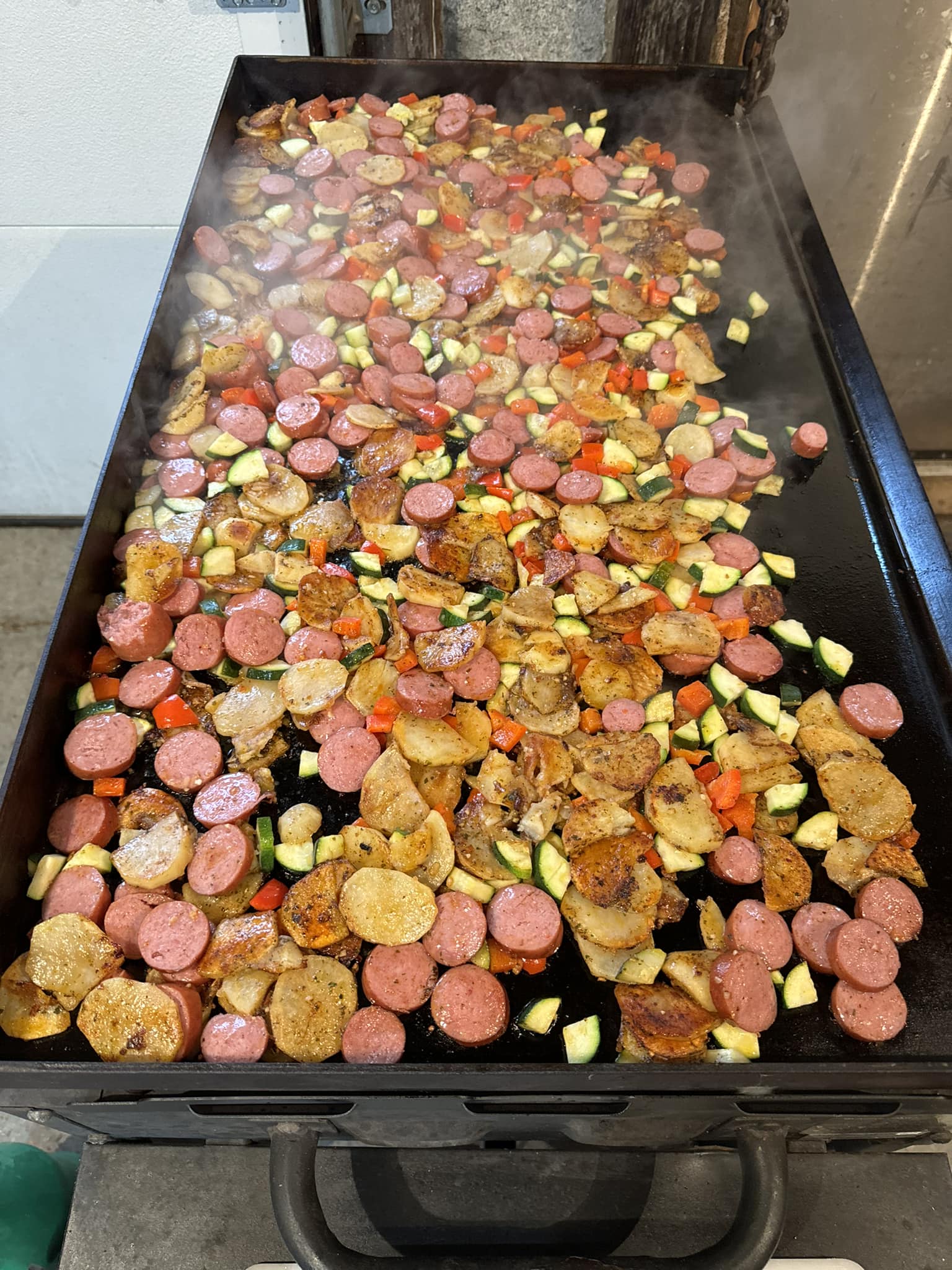 Colorful sausage‑potato stir fry ready to serve.