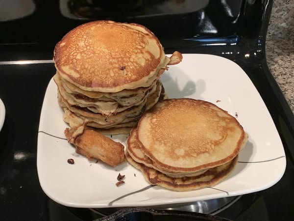 Tall stack of cast iron buttermilk pancakes on plate