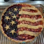 American flag berry pie before baking, stripes and stars raw on crust