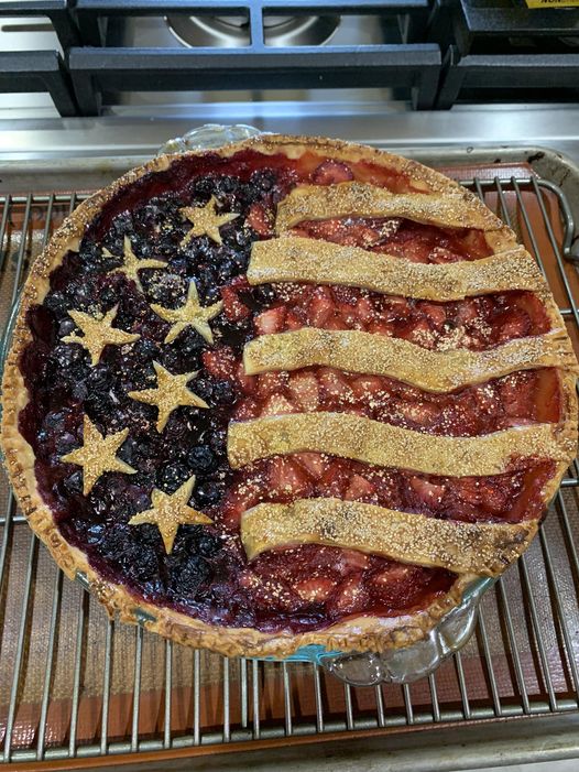 American flag berry pie before baking, stripes and stars raw on crust