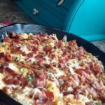Golden cheesy chipotle cauliflower rice casserole with bacon fresh from oven
