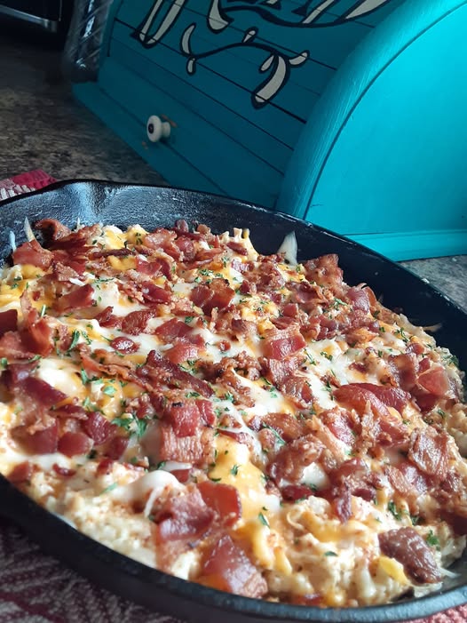 Golden cheesy chipotle cauliflower rice casserole with bacon fresh from oven