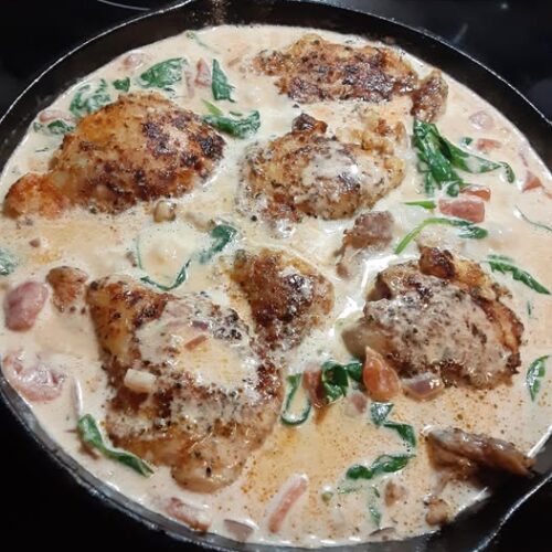 Golden‑seared chicken thighs nestled in creamy Tuscan spinach sauce