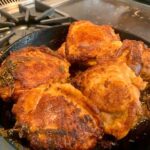 Cast iron chicken thighs searing skin down – golden brown