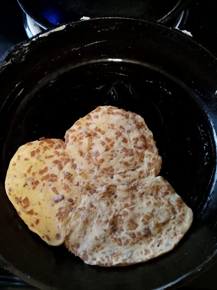 cinnamon rolls pressed into cast iron skillet to form crust]