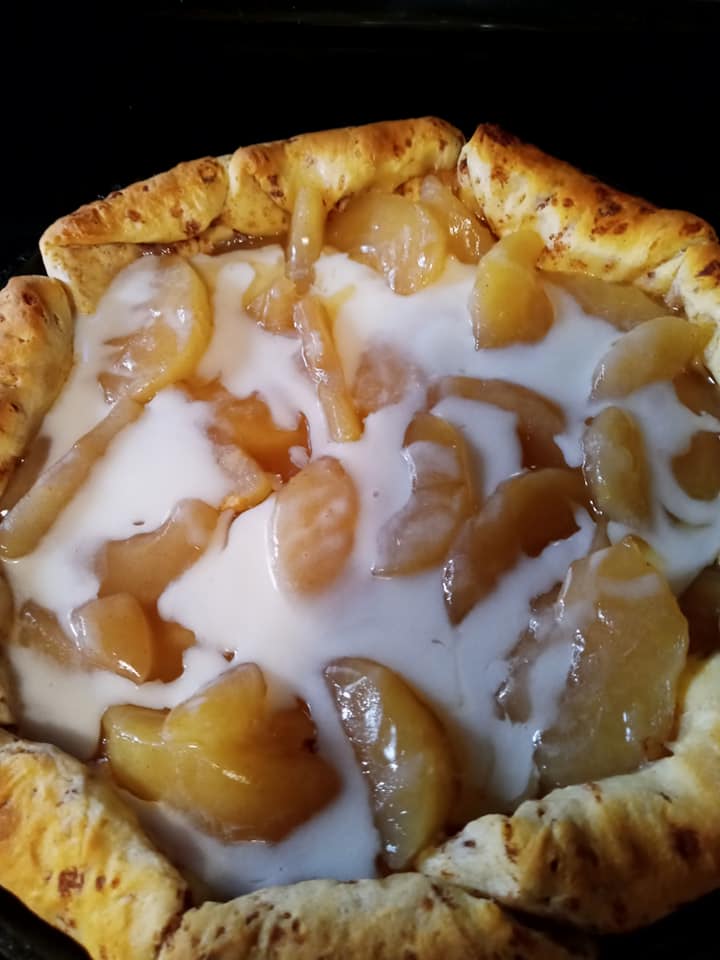 golden baked apple cinnamon roll pie cooling in skillet
