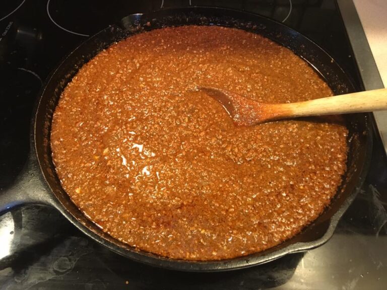 old fashioned hot dog meat sauce simmering in cast iron skillet