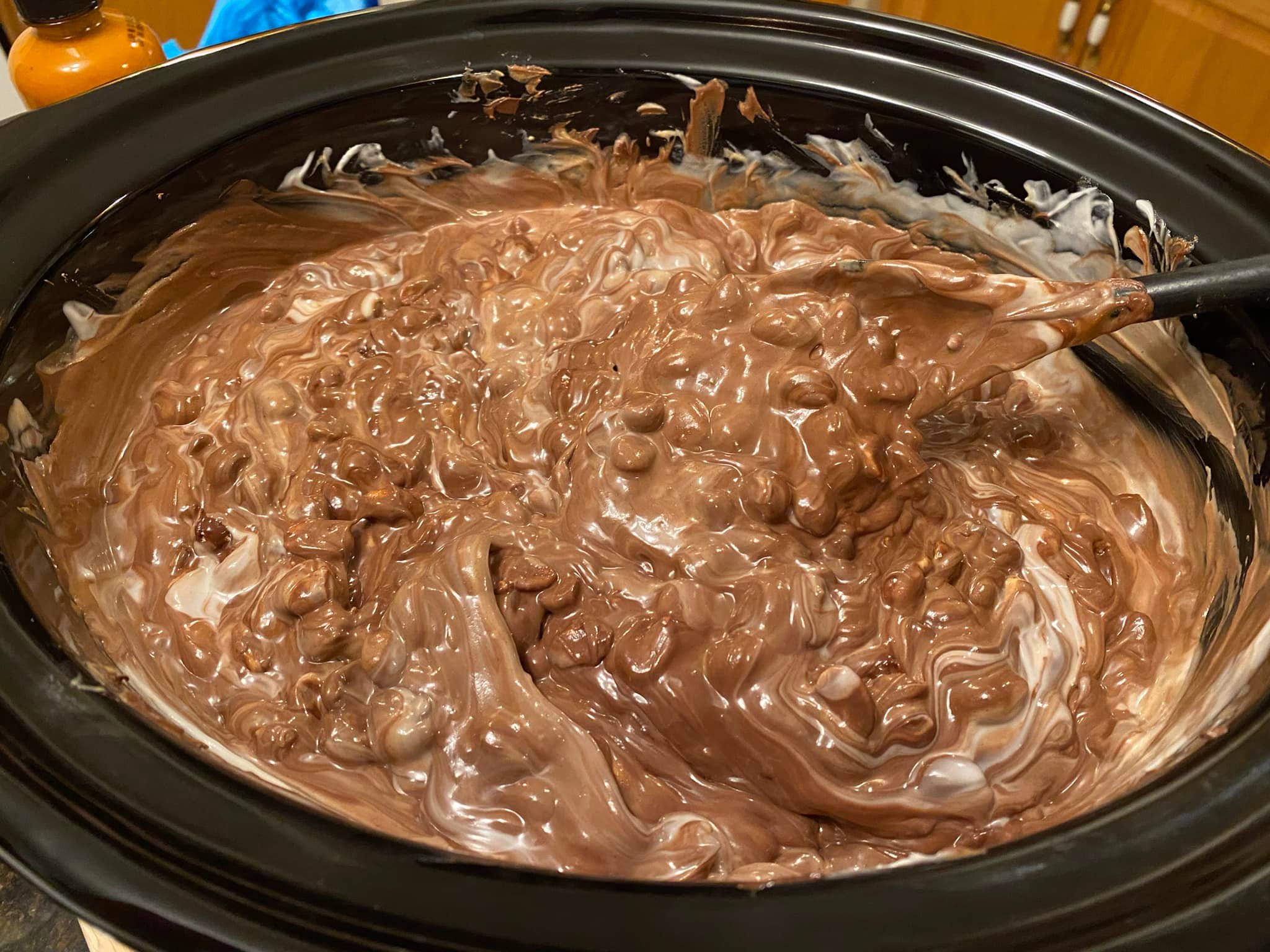 Chocolate, almond bark, and peanut butter chips melted and stirred together in crockpot