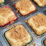 Brownie pan lined with colorful cupcake liners ready for batter