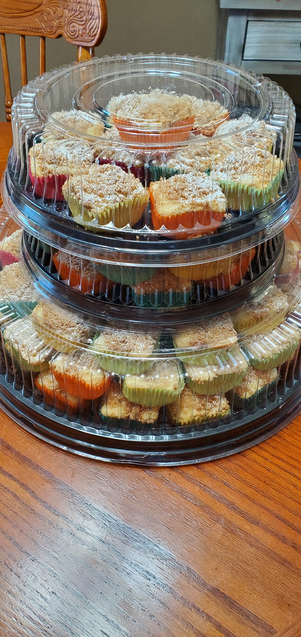 Freshly baked mini crumb cakes with golden crumb topping cooling in liners