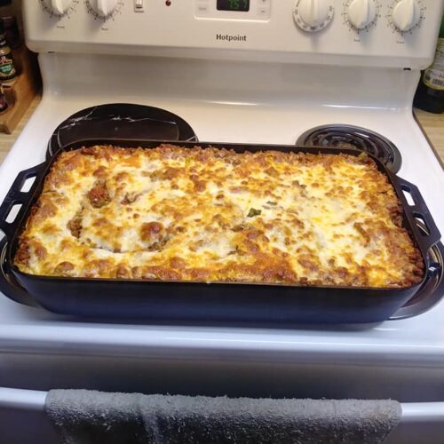 golden bubbly giant lasagna fresh from oven in fish pan