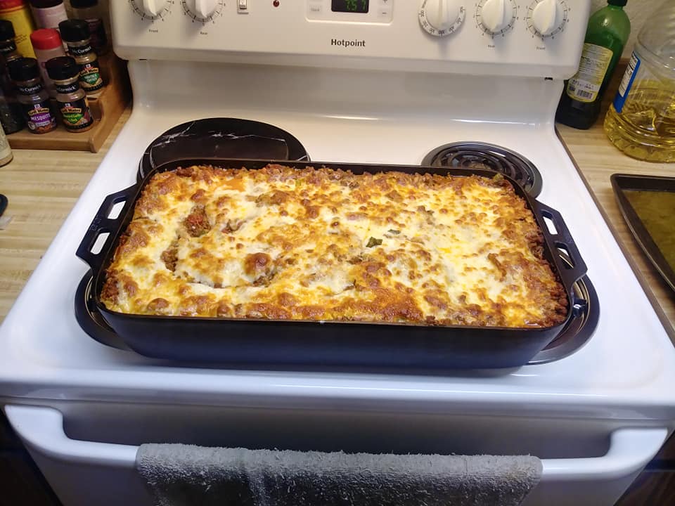 golden bubbly giant lasagna fresh from oven in fish pan