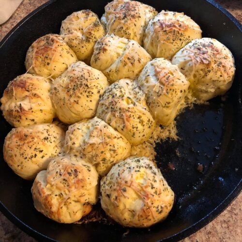 Golden baked garlic parmesan skillet rolls in cast iron skillet