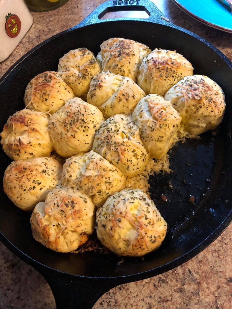 Golden baked garlic parmesan skillet rolls in cast iron skillet