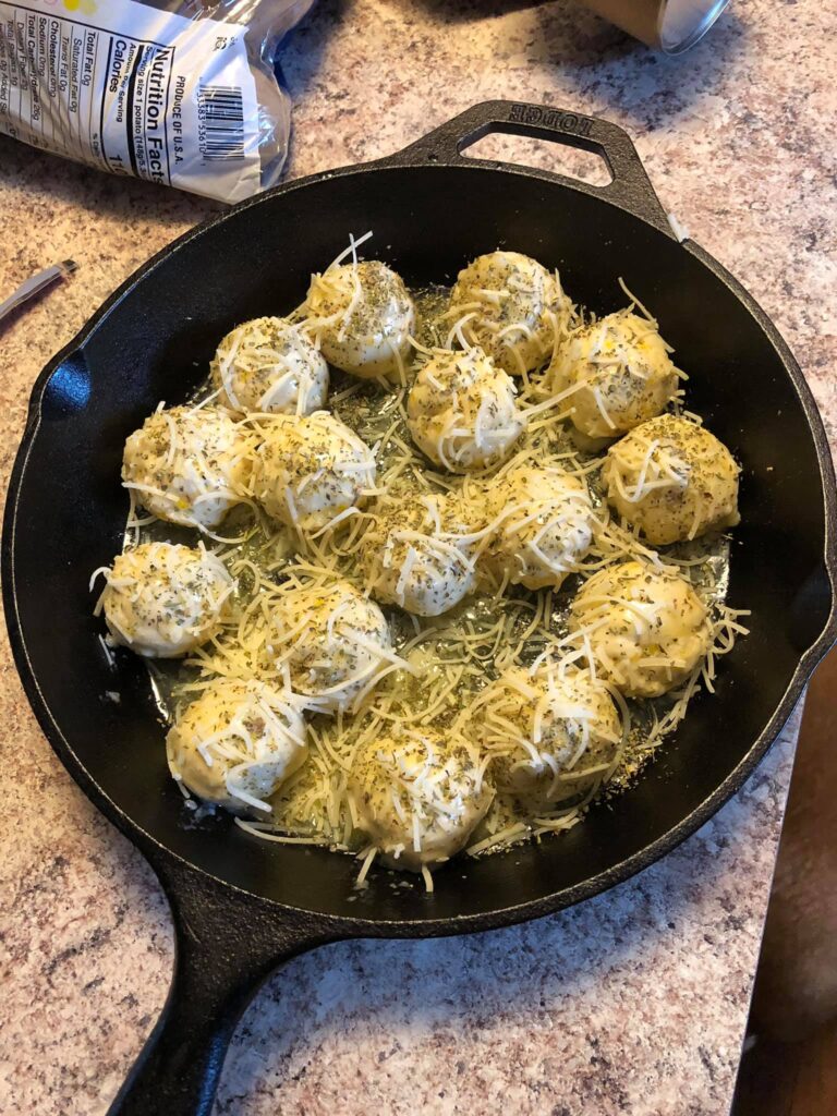 Unbaked garlic parmesan skillet rolls in cast iron skillet