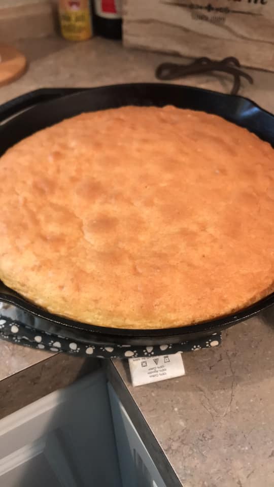 golden strawberry upside down cake in cast iron skillet before flipping