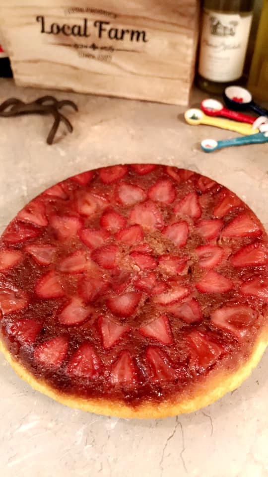 strawberry upside down cake flipped onto plate showing caramelized strawberries