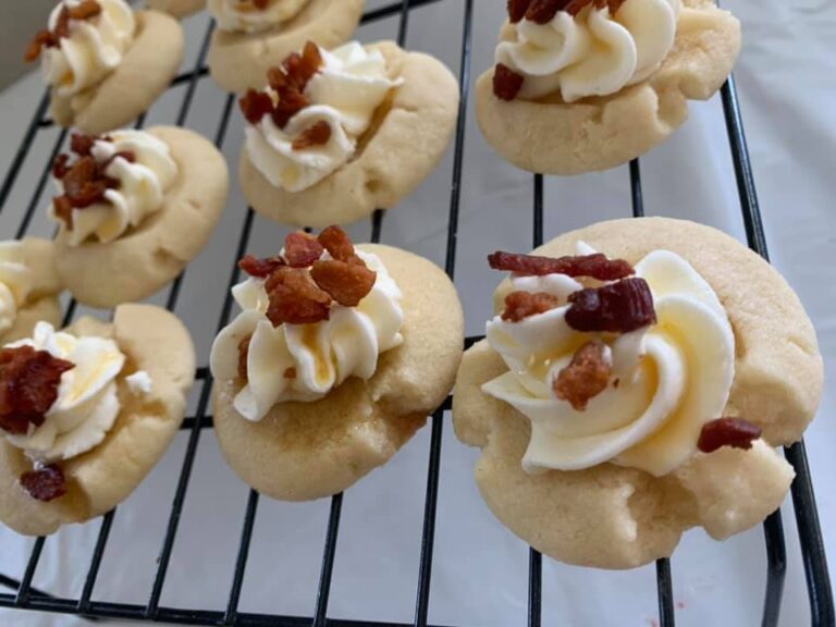 Maple shortbread cookies topped with bourbon frosting, bacon, and maple drizzle
