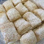 uff pastry pillows filled with cream and dusted with powdered sugar