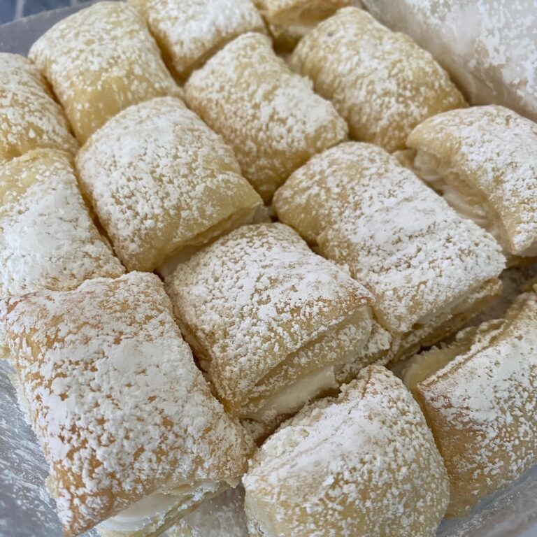 uff pastry pillows filled with cream and dusted with powdered sugar
