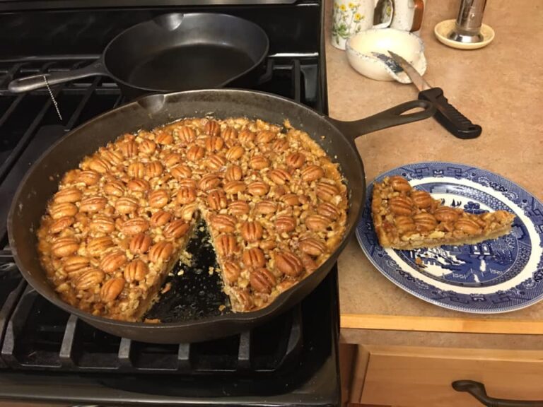 Southern cast iron pecan tart baked in 12-inch skillet with golden pecans and flaky crust