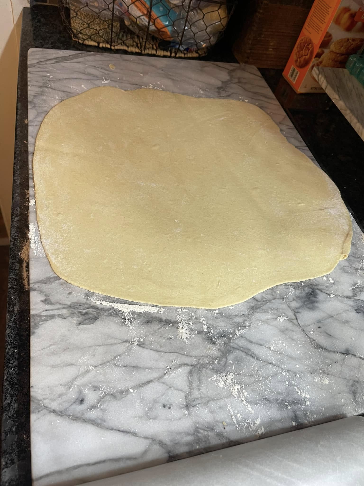 clothespin cookie dough rolled thin on a floured marble surface]