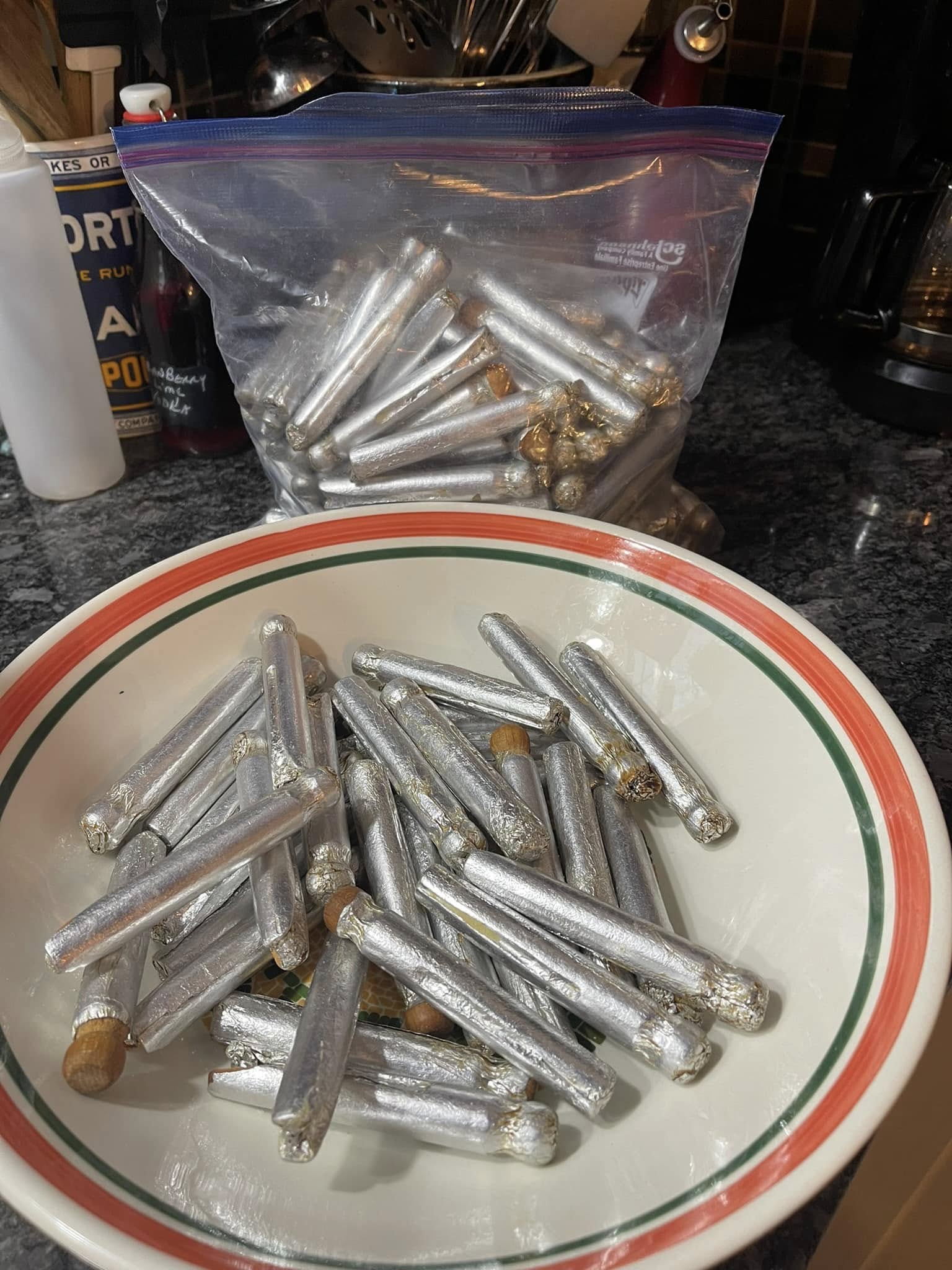 vintage metal and wooden clothespins wrapped in foil in a bowl ready for cookie shaping