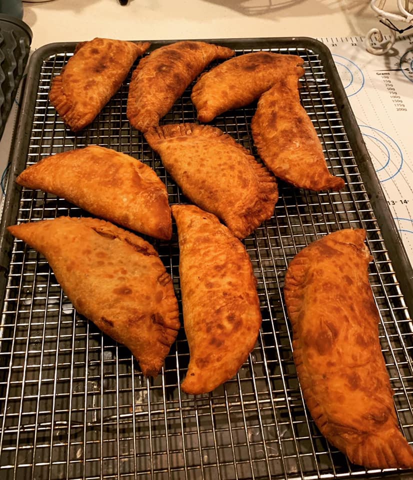 freshly fried pies cooling on a wire rack, golden and crisp