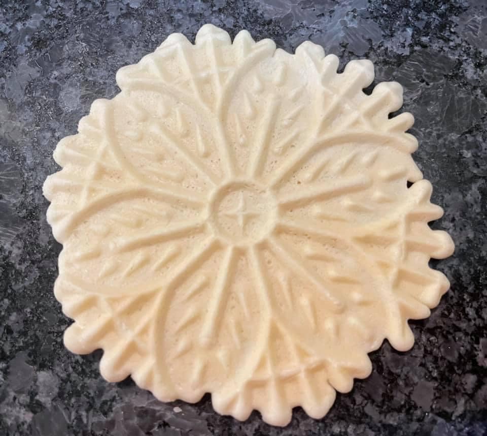 detailed close-up of a beautifully patterned Italian pizzelle cookie