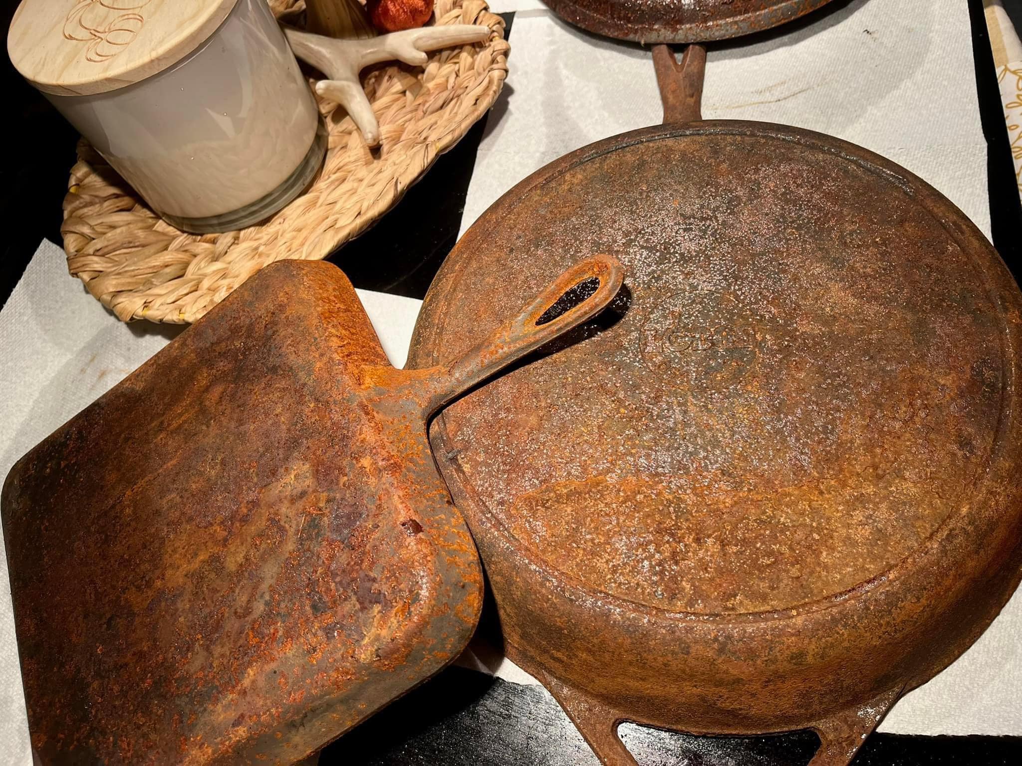 Heavily rusted vintage cast iron pans before cleaning process