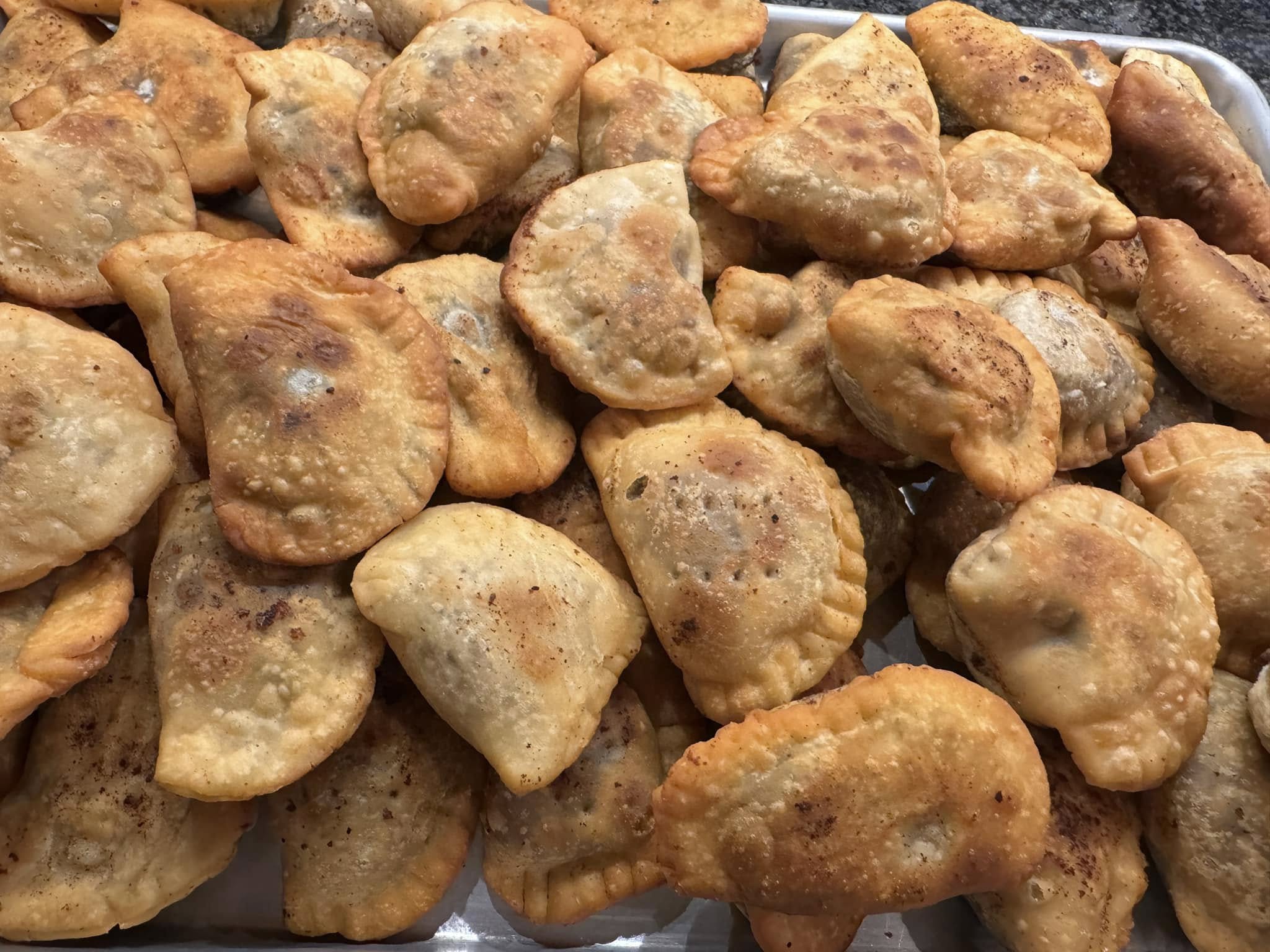 finished fritters on holiday plate | Alt text: finished Italian chickpea fritters dusted with powdered sugar on Christmas plate