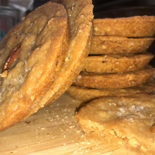 stack of old fashioned butter pecan shortbread cookies with pecan halves and sanding sugar]