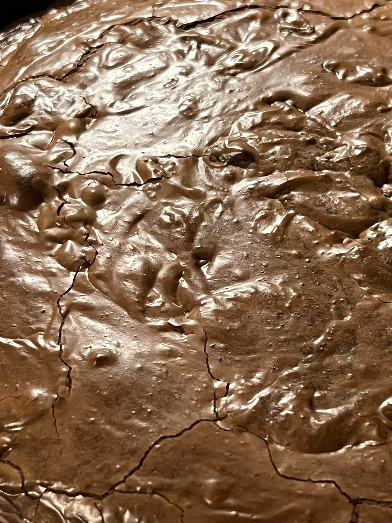 sourdough discard brownies cooling on a stovetop in a 12-inch cast iron pan
