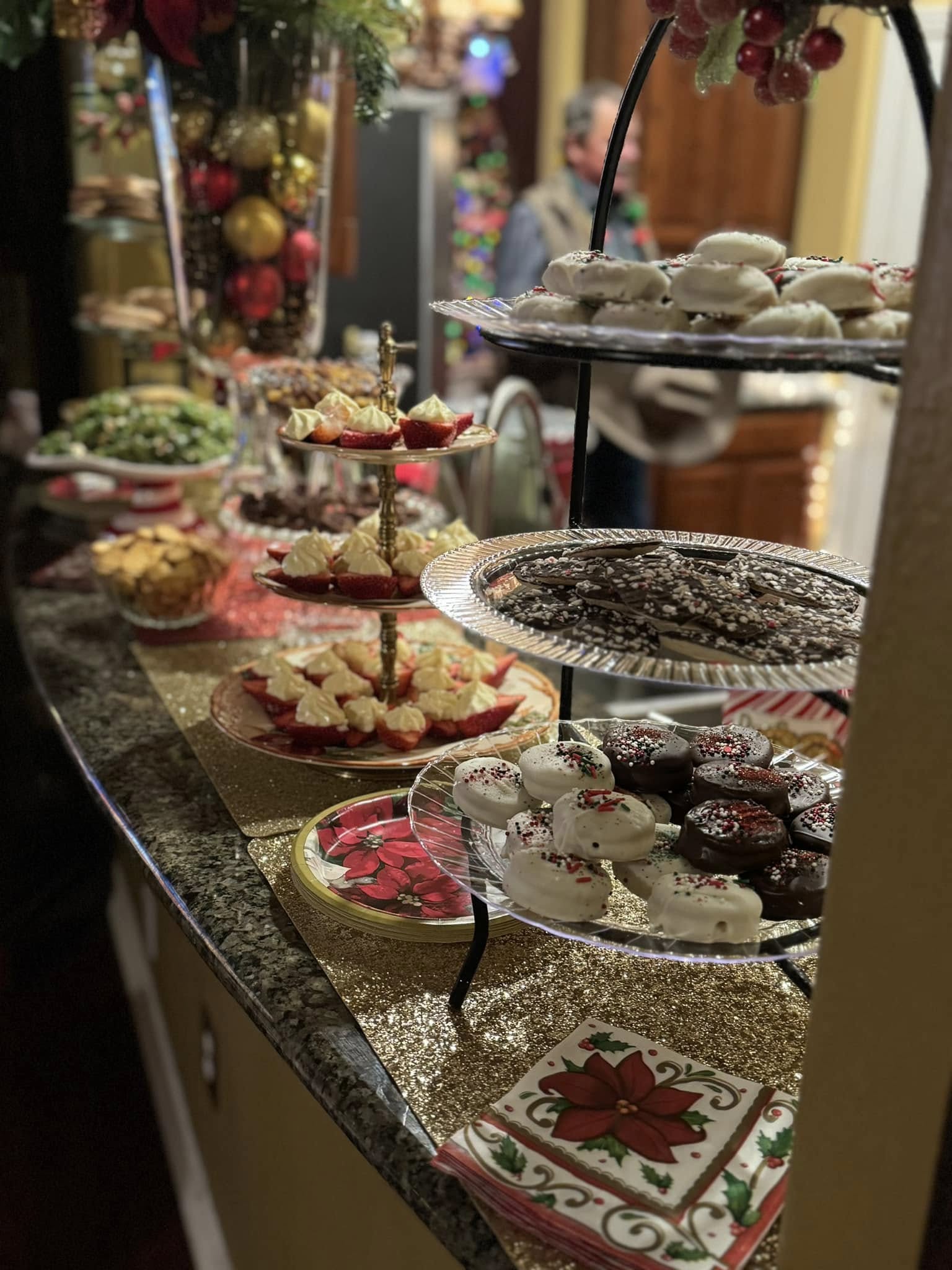 A holiday cocktail station featuring blue Jack Frost drinks, red Christmas Margaritas, and pink Peppermint Spritzers with festive sugared rims