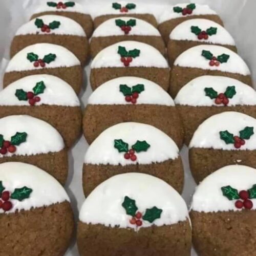 A white box filled with neat rows of Christmas Pudding ginger cookies ready for a holiday gift exchange