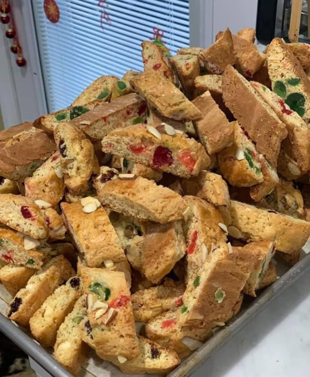 A large tray filled with dozens of twice-baked biscotti ready for packaging