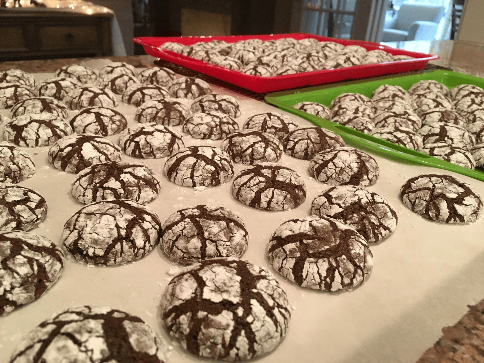A stack of freshly baked chocolate brownie mix crinkle cookies coated in powdered sugar