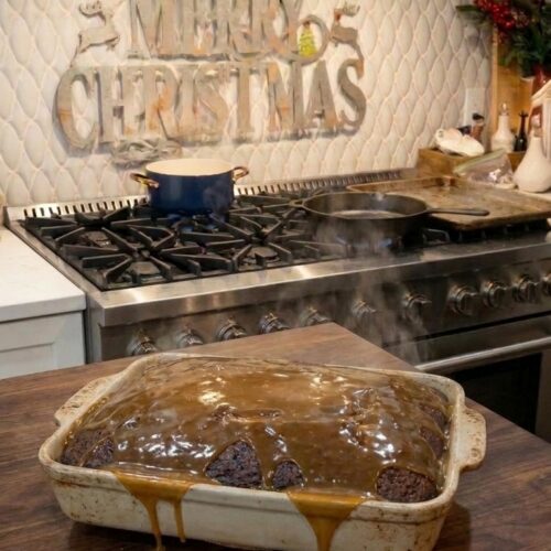 Thick squares of homemade 3-ingredient peanut butter fudge stacked on a wooden serving board, showing a smooth, creamy golden peanut butter texture.